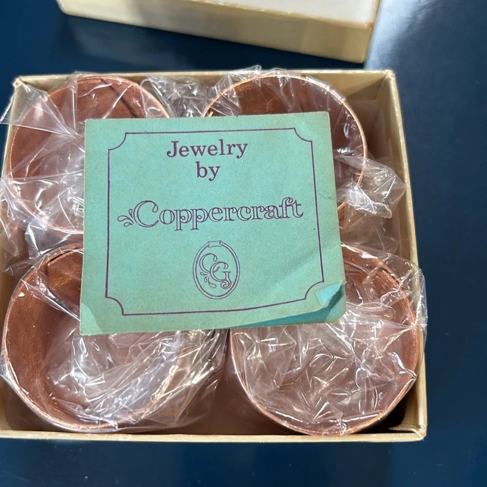Vintage Coppercraft set of 4 copper napkin rings in box.